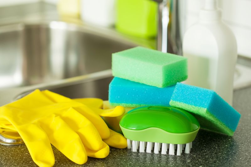 A person cleaning with a sponge.
