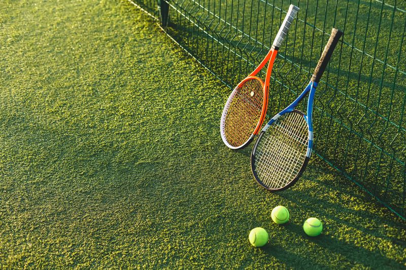 An image displaying a tennis racket and tennis ball.