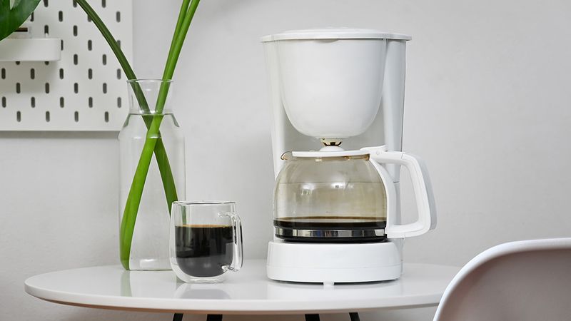An image displaying a mixer, pot, and cup.