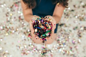 A person holding confetti and sweets.