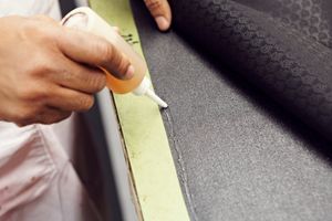 A person writing indoors with a stained finger.