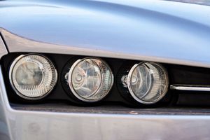 An image of a car with a headlight and wheel.