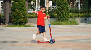 A boy riding an e-scooter.