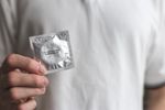 An image of a person's hand holding aluminum foil.