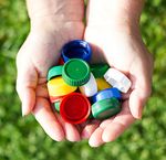 An image of a person's hand holding medication and tape.