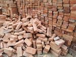 Stack of lumber, wood, and bricks.